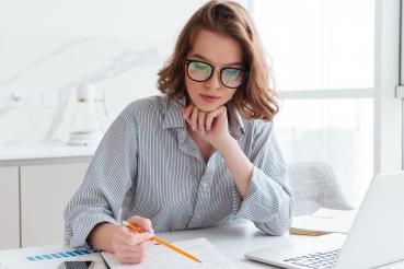 0001_young-concentrated-businesswoman-glasses-striped-shirt-working-with-papers-home-min_1668760676-d6f3b3471639c2ec60c3d7ad30b7e3e1.jpg
